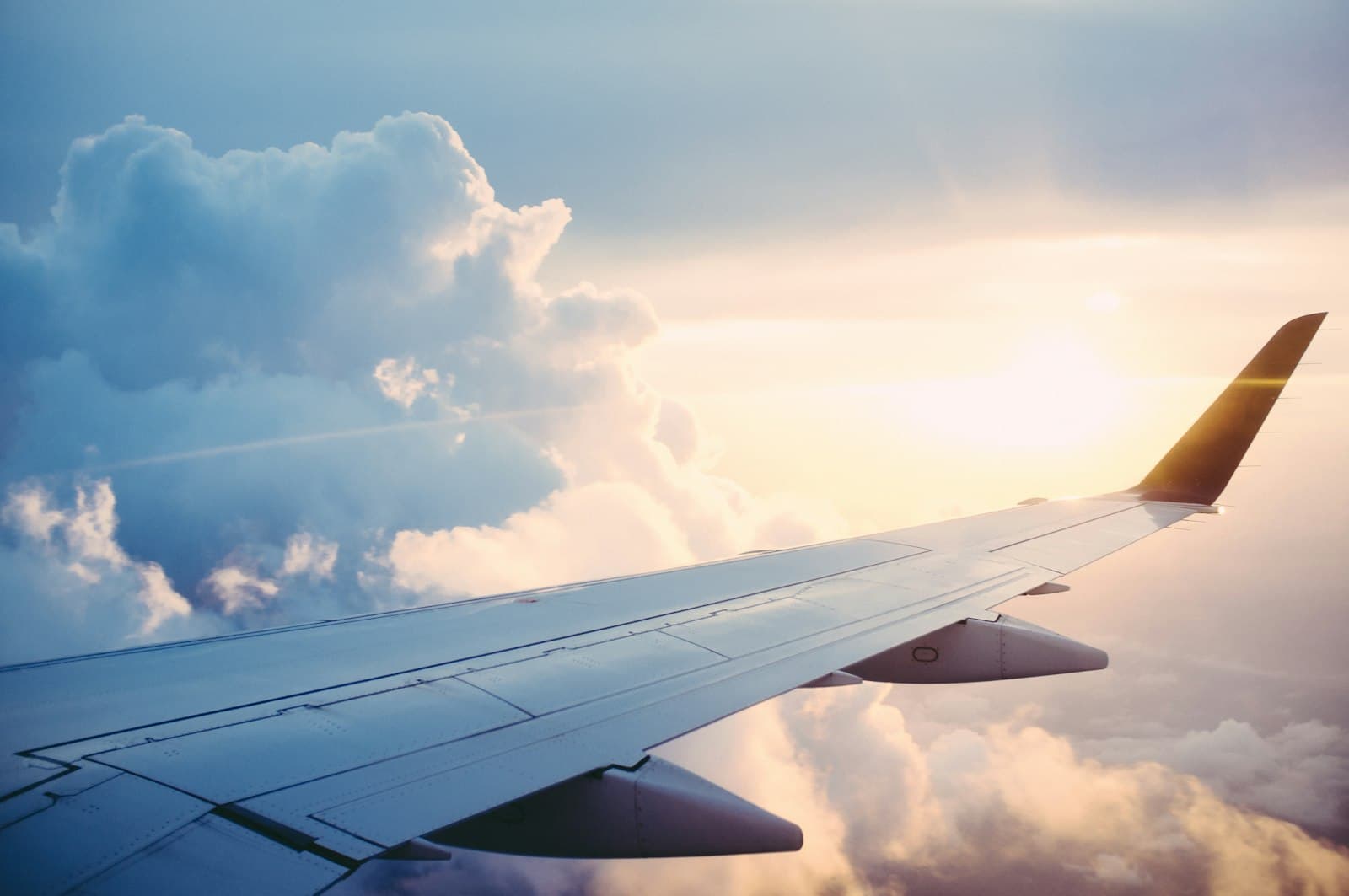 View from an airplane window above the clouds